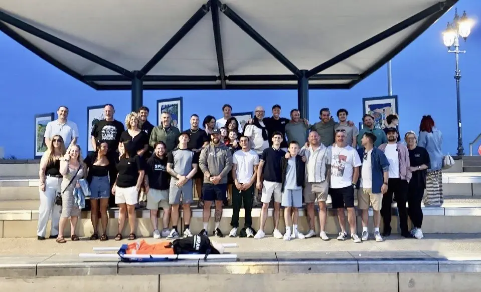 A large group of SPEAK community members together at an event
